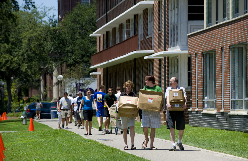 Family helping move in their kids