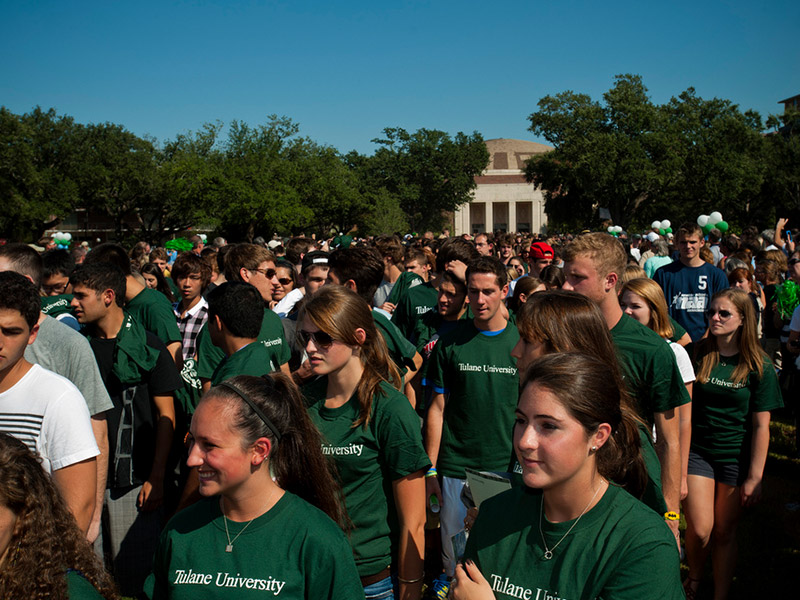 Students outside all wearing green shirts