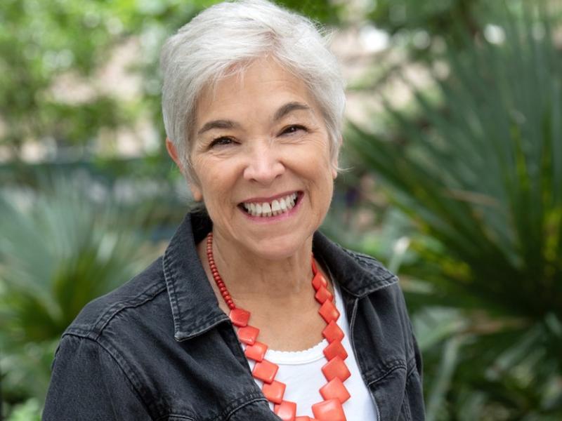 woman smiling with coral necklace