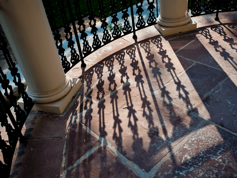 shadow on alumni house railing