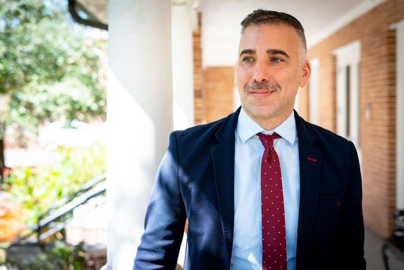 Man in suit standing on porch
