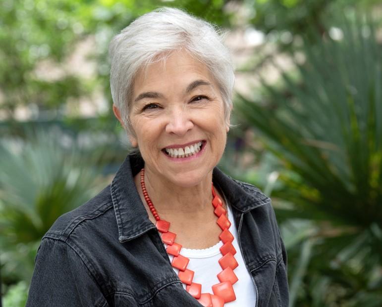 woman smiling with coral necklace